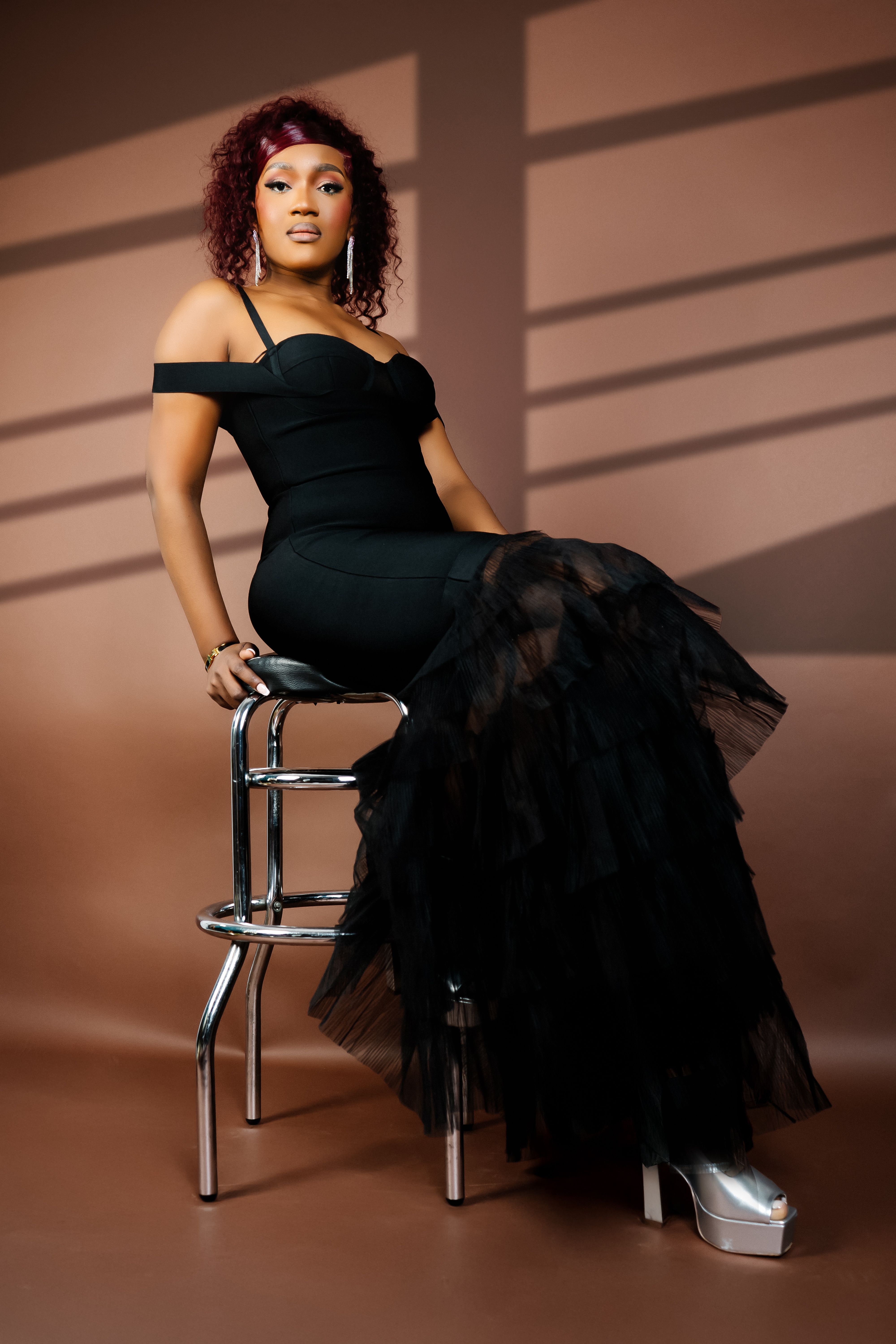 Elegant Woman Posing in Stylish Black Dress · Free Stock Photo