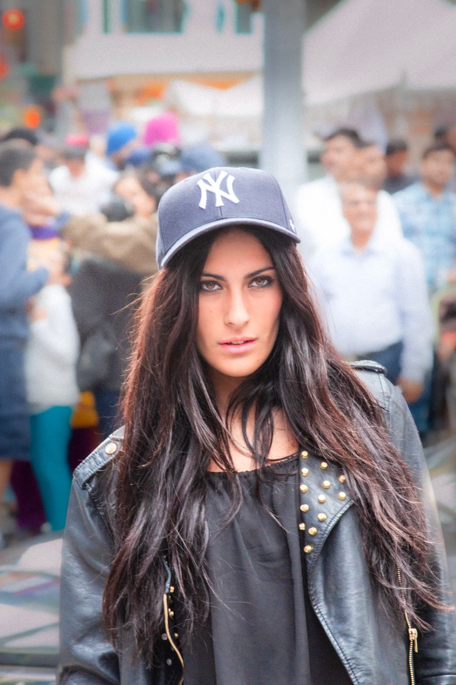 Stylish model in urban streetwear and a black leather jacket