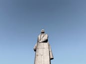 Statue of Historical Figure Under Blue Sky