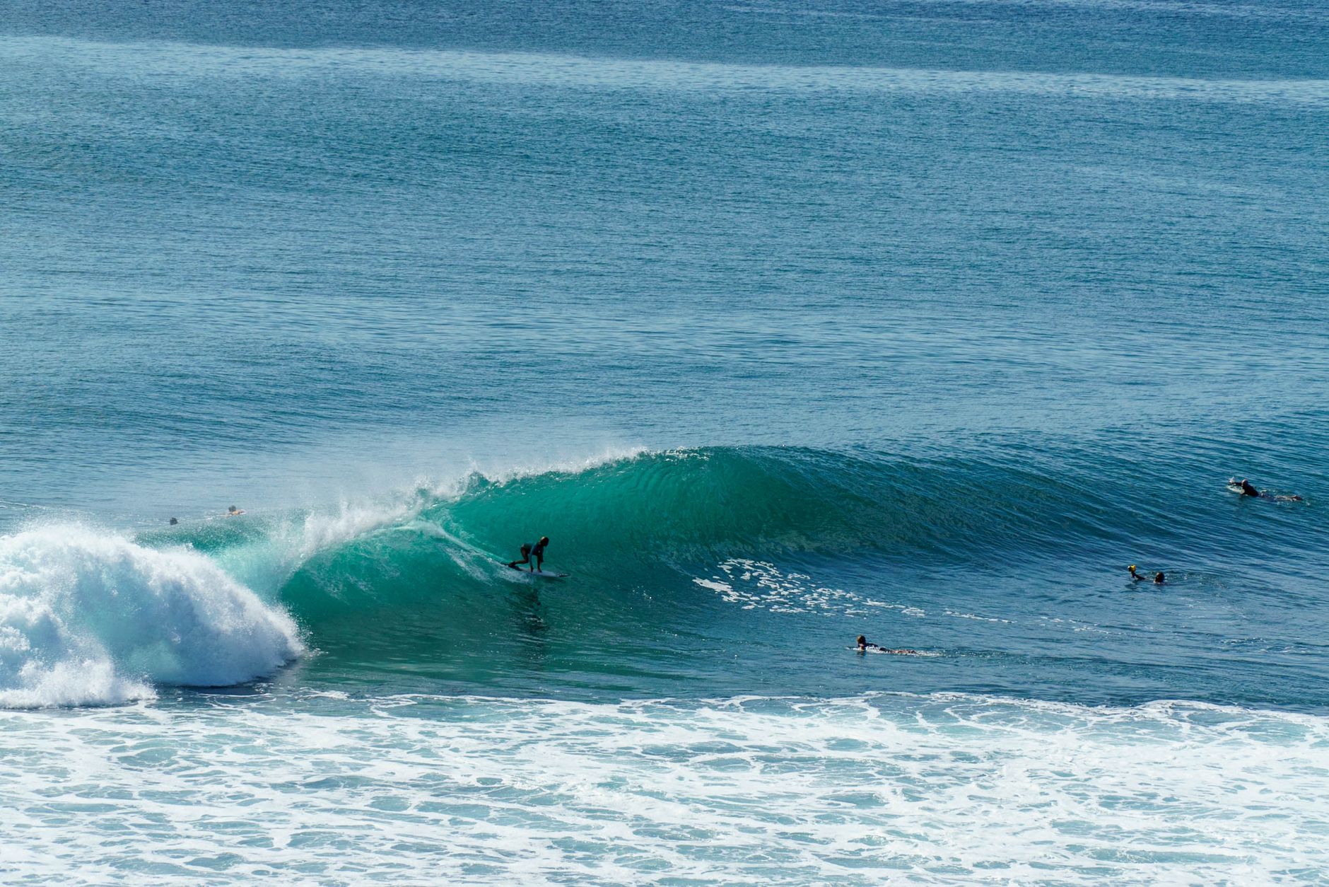 A dynamic scene of a surfer catching a powerful wave in Bali, showcasing vibrant ocean action.