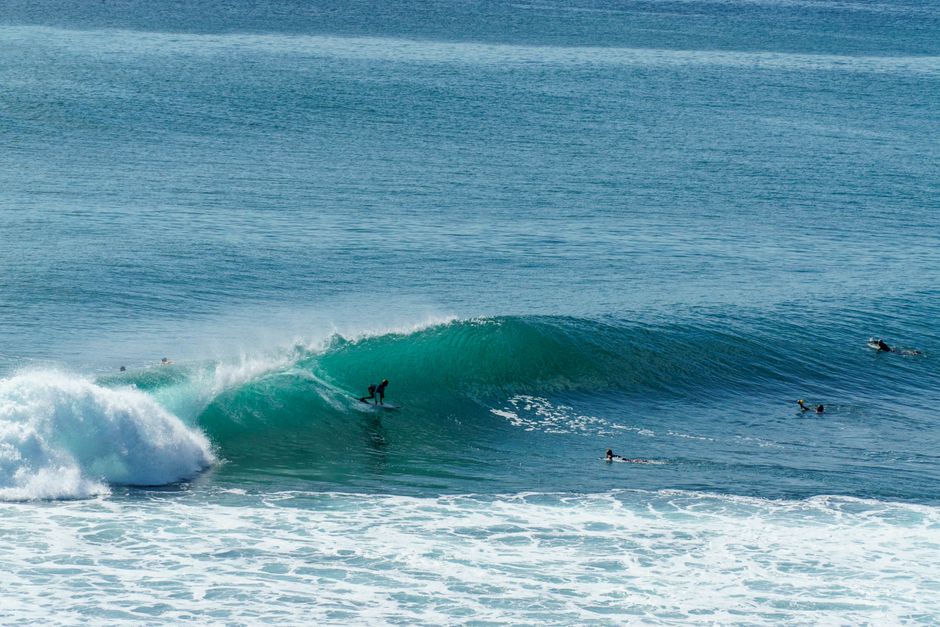 A dynamic scene of a surfer catching a powerful wave in Bali, showcasing vibrant ocean action.