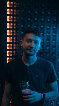 Casual portrait of a man enjoying a drink at a bar in Buenos Aires, Argentina.