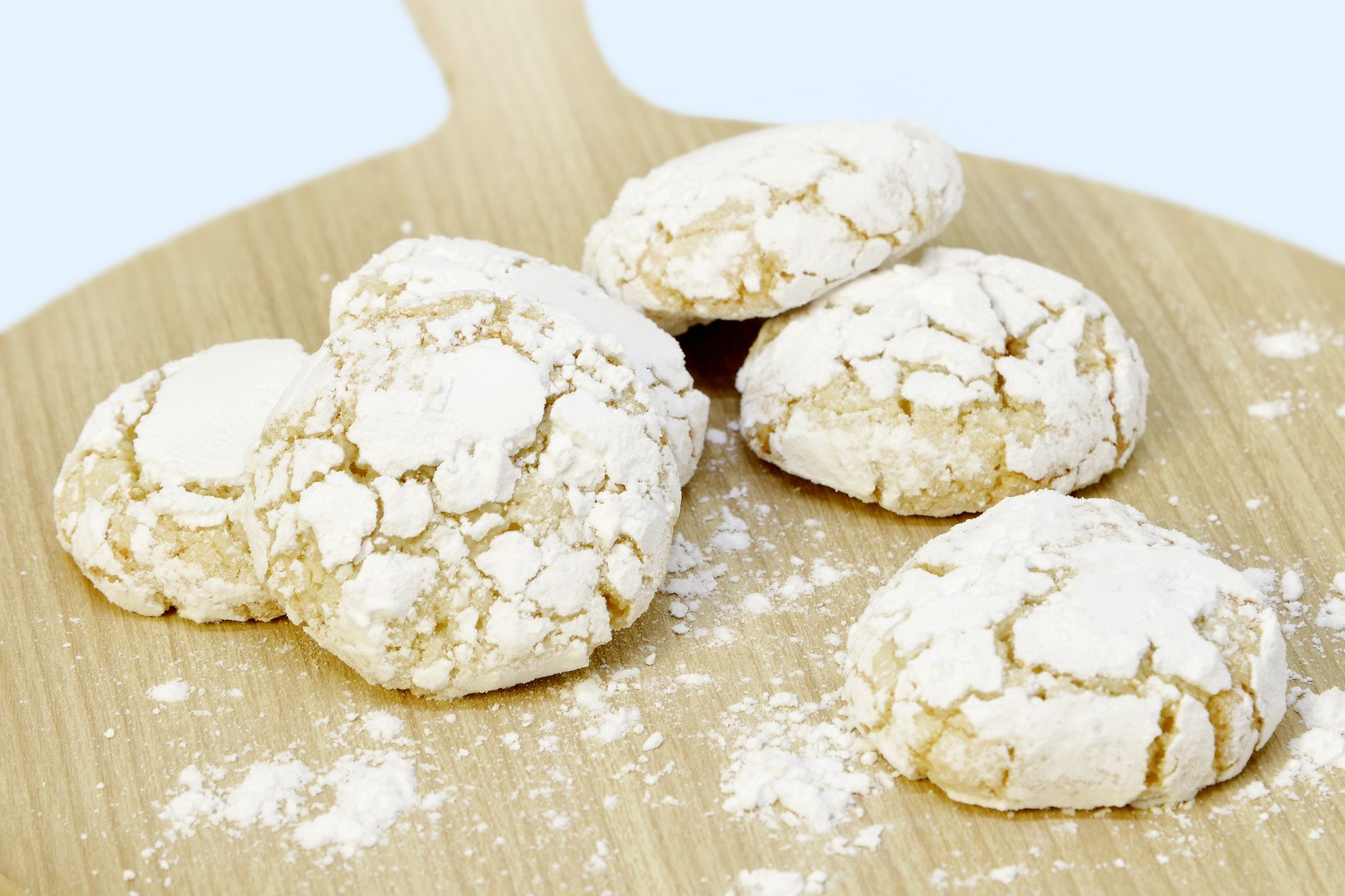 Close-up of crispy almond cookies stored in a glass jar