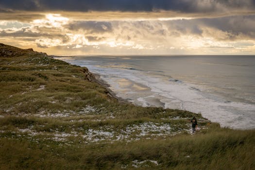 Beautiful beach view in Agger, Denmark under dramatic sky.