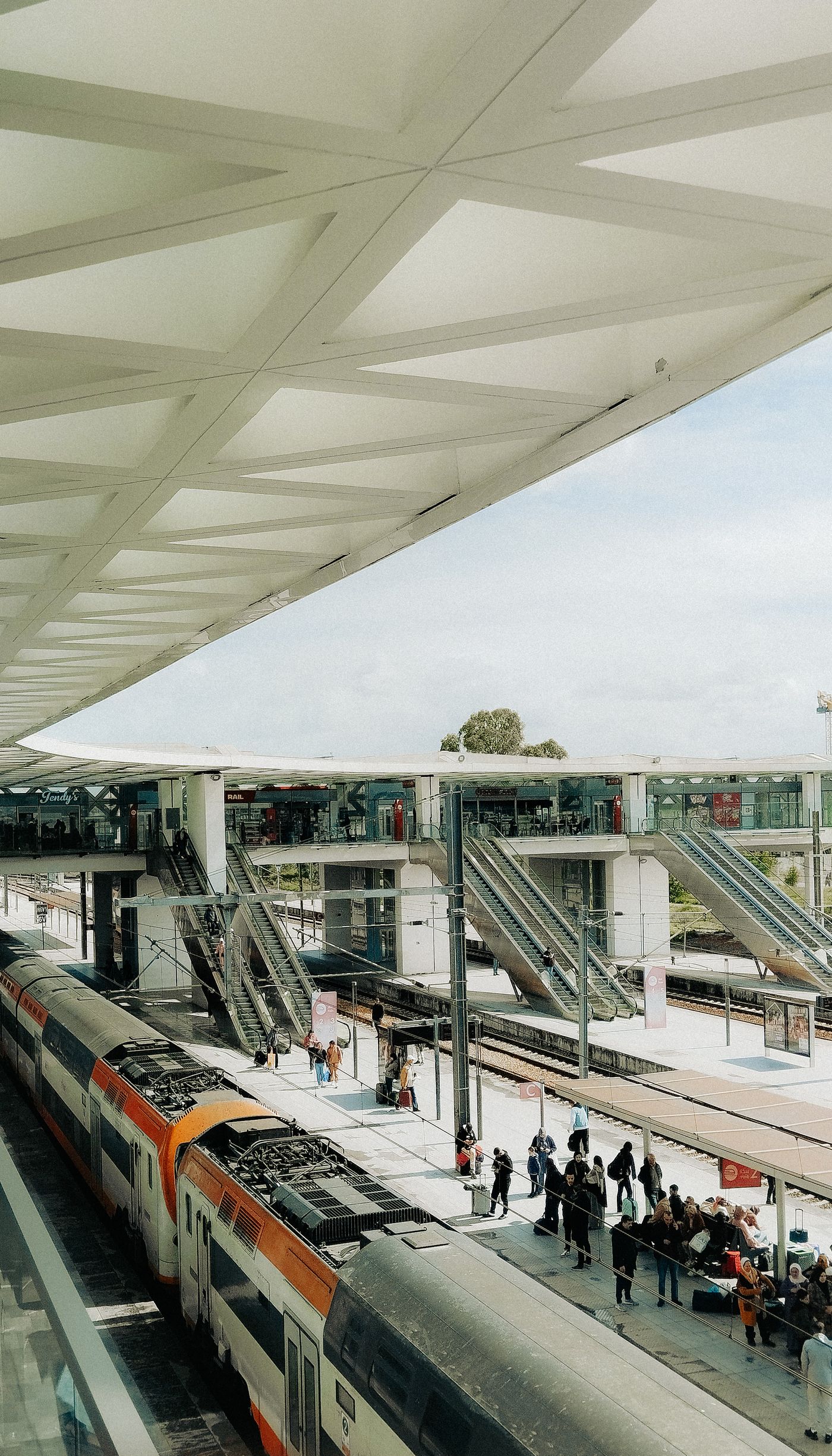 Modern railway station in Rabat, Morocco, with passengers on the platform