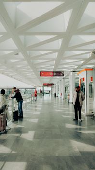 People in a sleek modern airport terminal in Rabat, capturing travel and urban design.