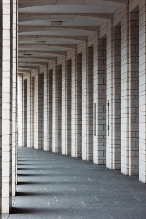 Free Symmetrical view of a modern arched corridor with pillars in Karlsruhe, Germany. Stock Photo