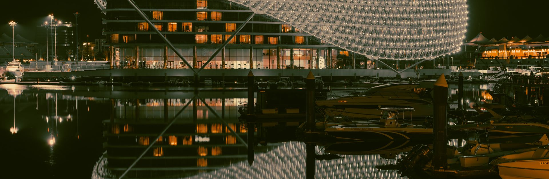 Beautiful night photograph of Yas Hotel in Abu Dhabi, showcasing its illuminated architecture and re
