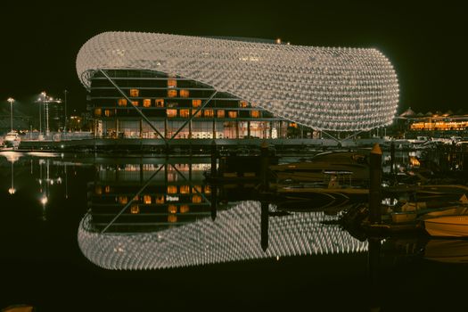 Beautiful night photograph of Yas Hotel in Abu Dhabi, showcasing its illuminated architecture and reflections.