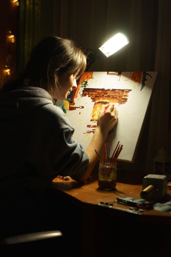 Painter scanning and digitizing a watercolor painting to prepare artwork for print on demand marketplaces