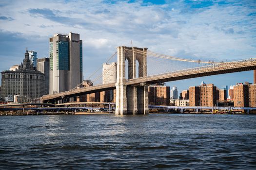 Iconic Brooklyn Bridge with the New York City skyline in clear daylight.