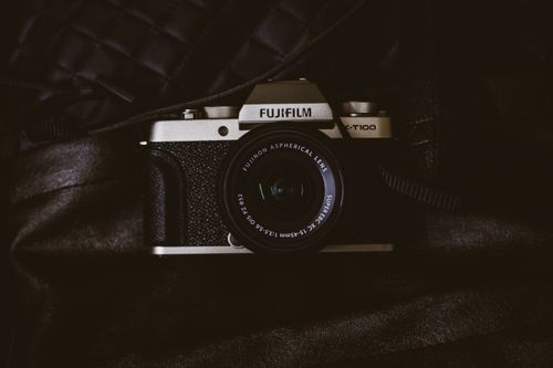Free Close-up of a vintage Fujifilm camera on a dark background, highlighting its classic design. Stock Photo