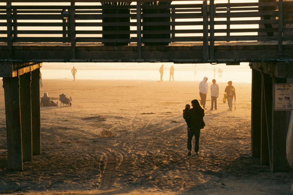 family beach boardwalk sunset