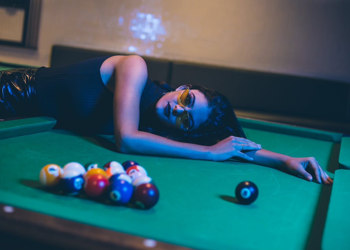 Woman Lying on Pool Table