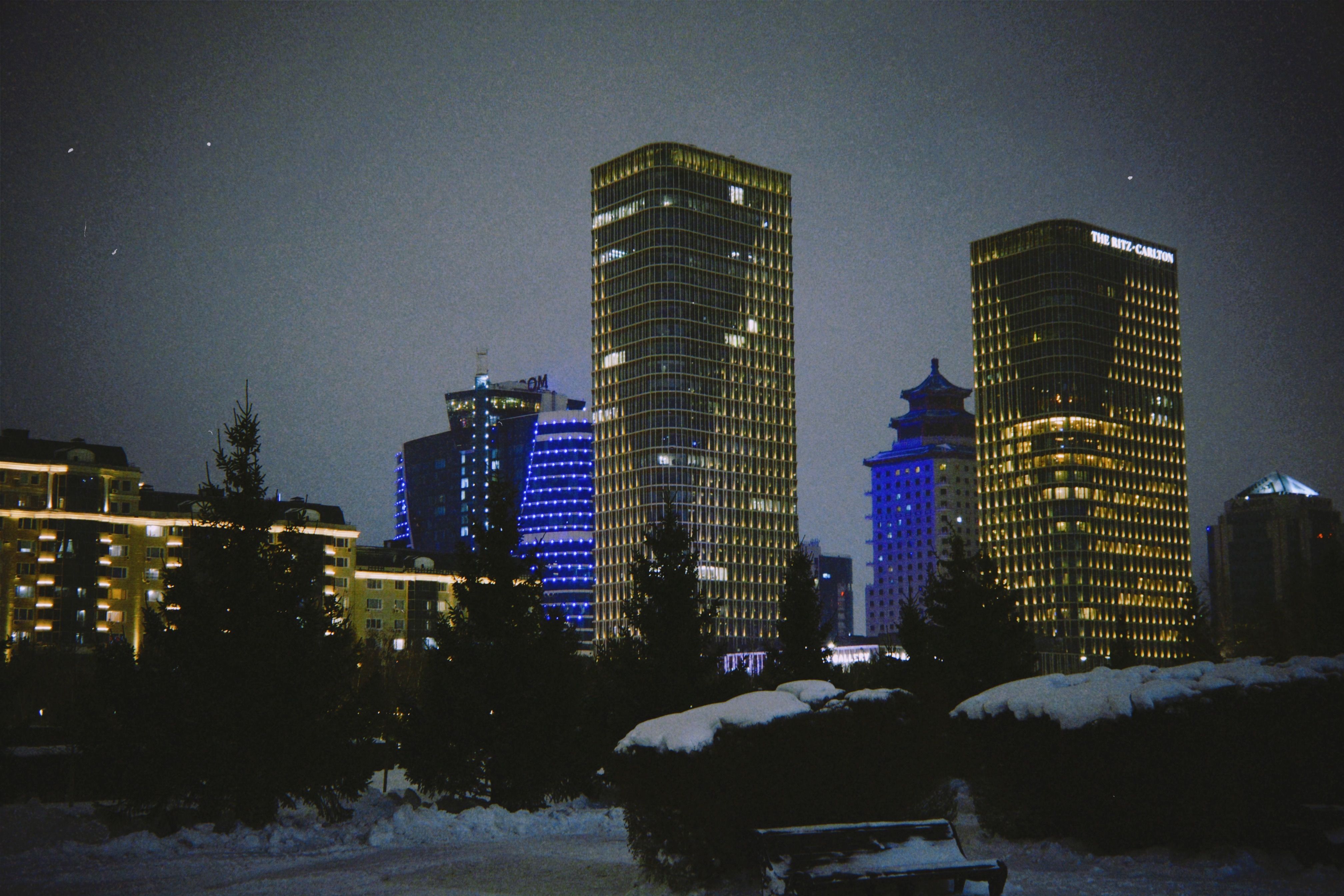 Stunning nighttime view of modern skyscrapers and buildings in Astana, Kazakhstan.
