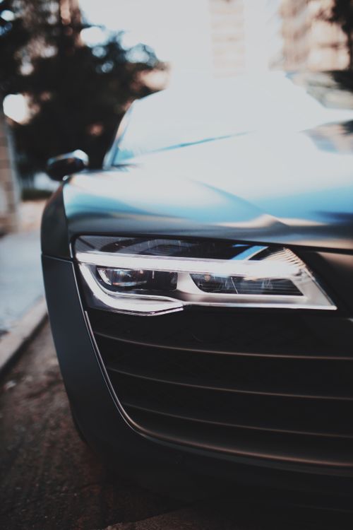 Free Close-up of a parked sports car showcasing sleek design and modern headlight. Stock Photo
