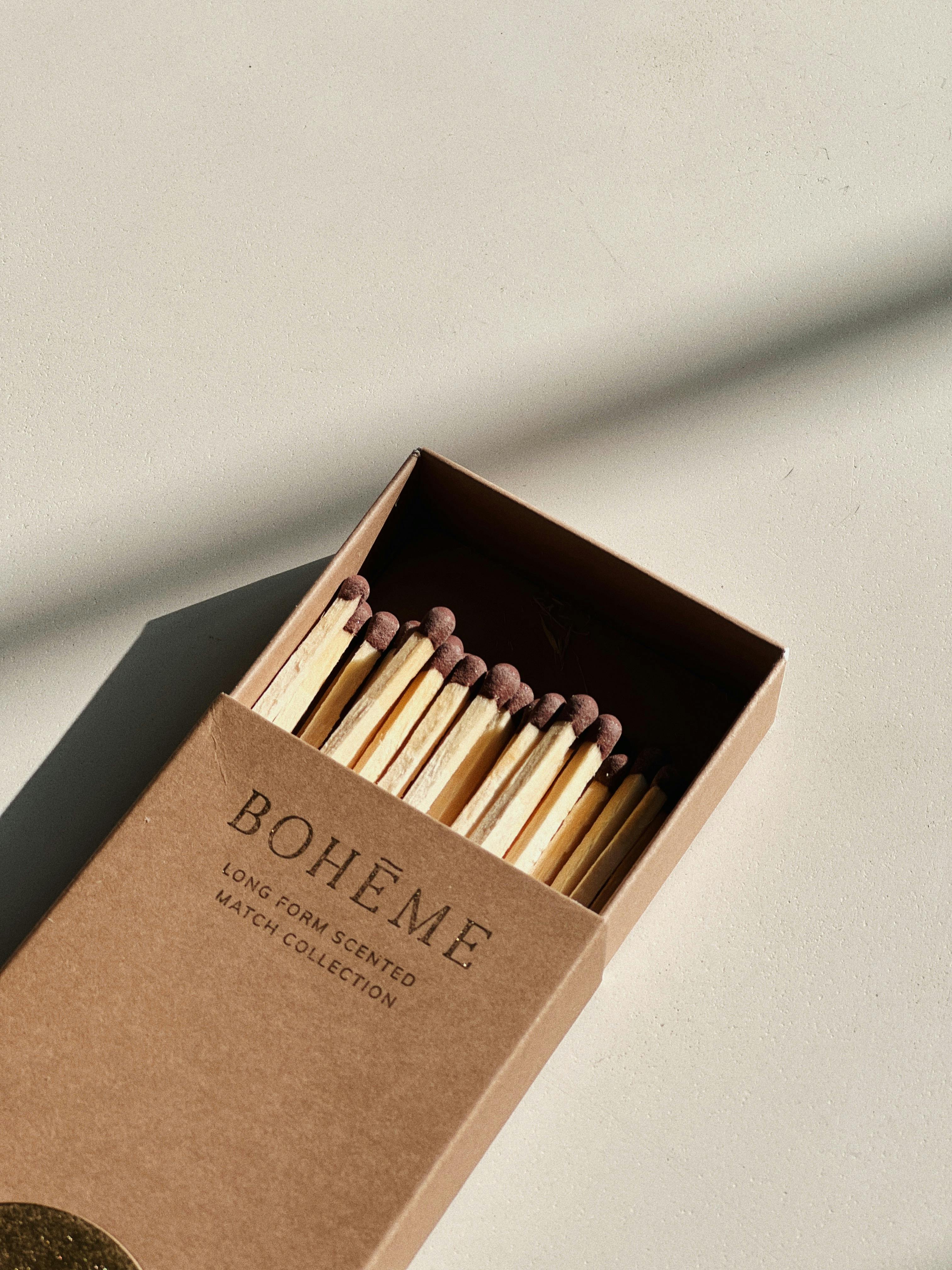 Sunlit Boheme matchbox showcasing its minimalist design with long-form scented matches.
