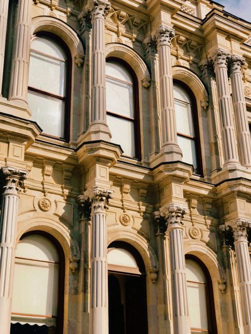 Close-up of a classic European building facade featuring ornate Corinthian columns.