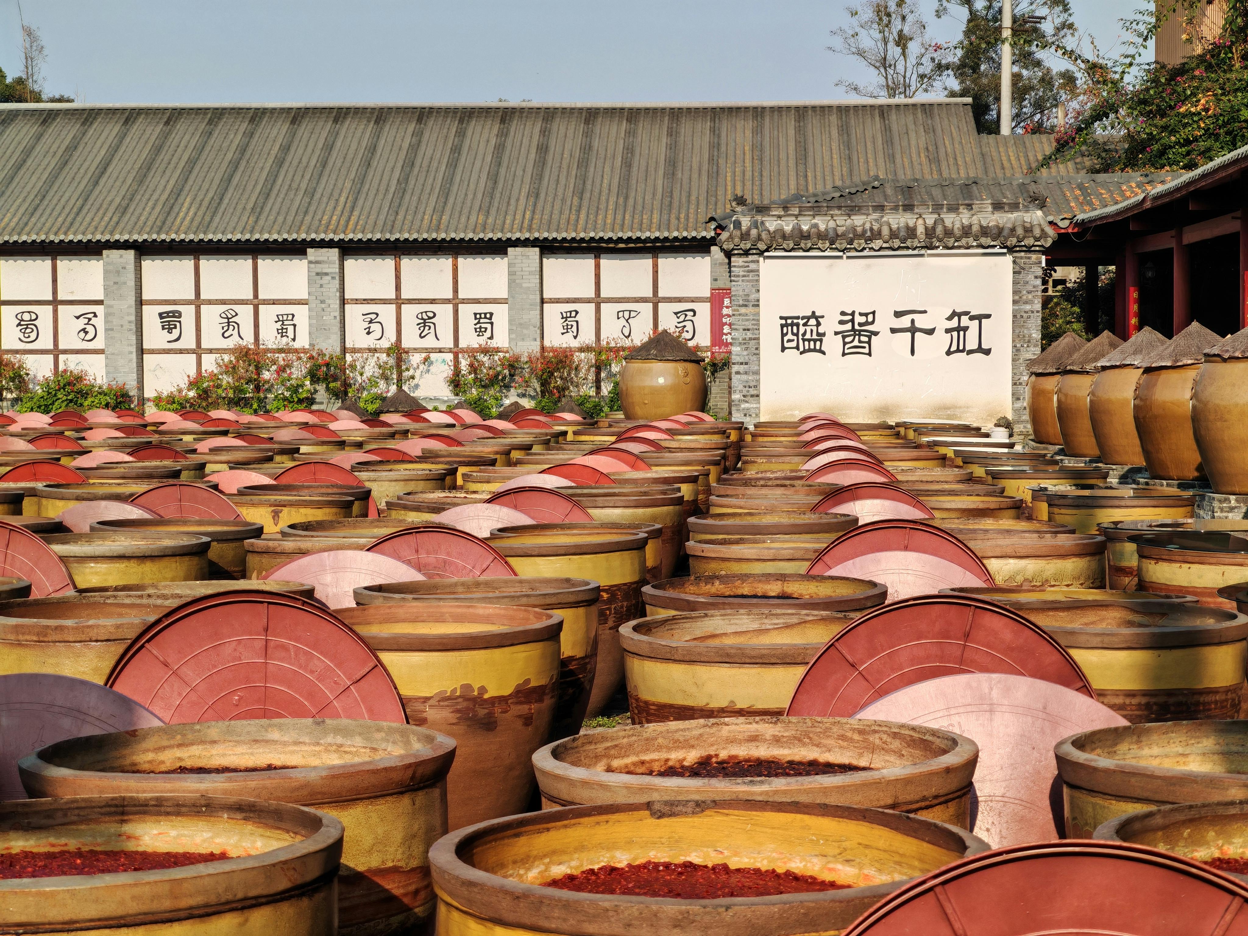 traditional chinese fermentation jars in courtyard