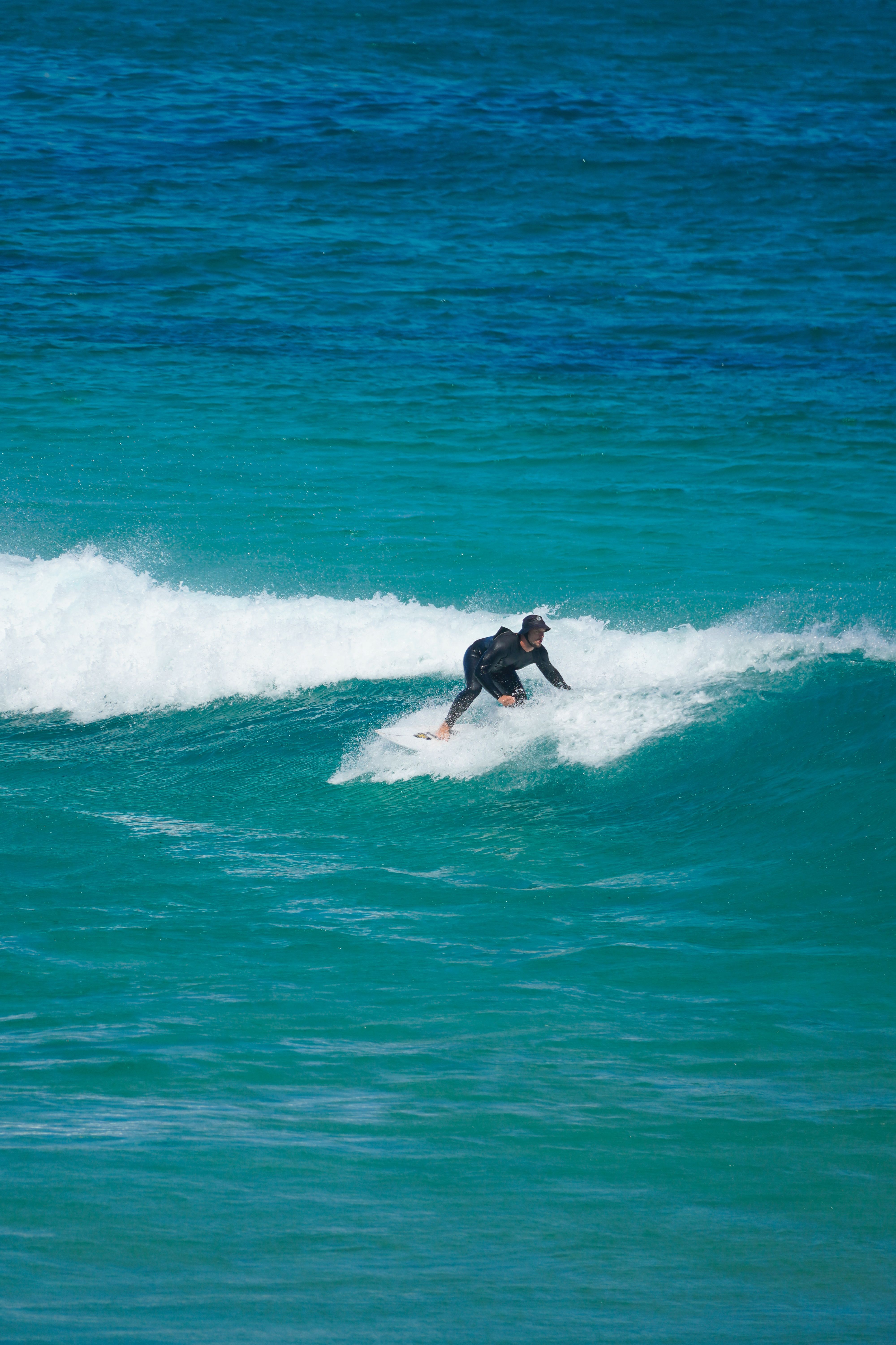 Surfer Riding Waves on Turquoise Ocean · Free Stock Photo