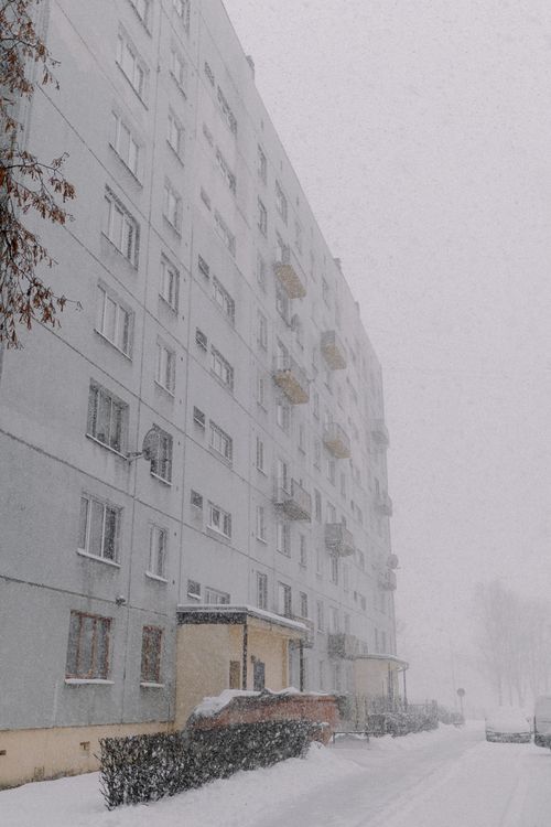 Free A snowy scene of an apartment building during a winter storm. Stock Photo