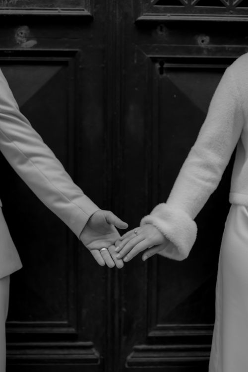 Elegant Black and White Bridal Couple Holding Hands · Free Stock Photo