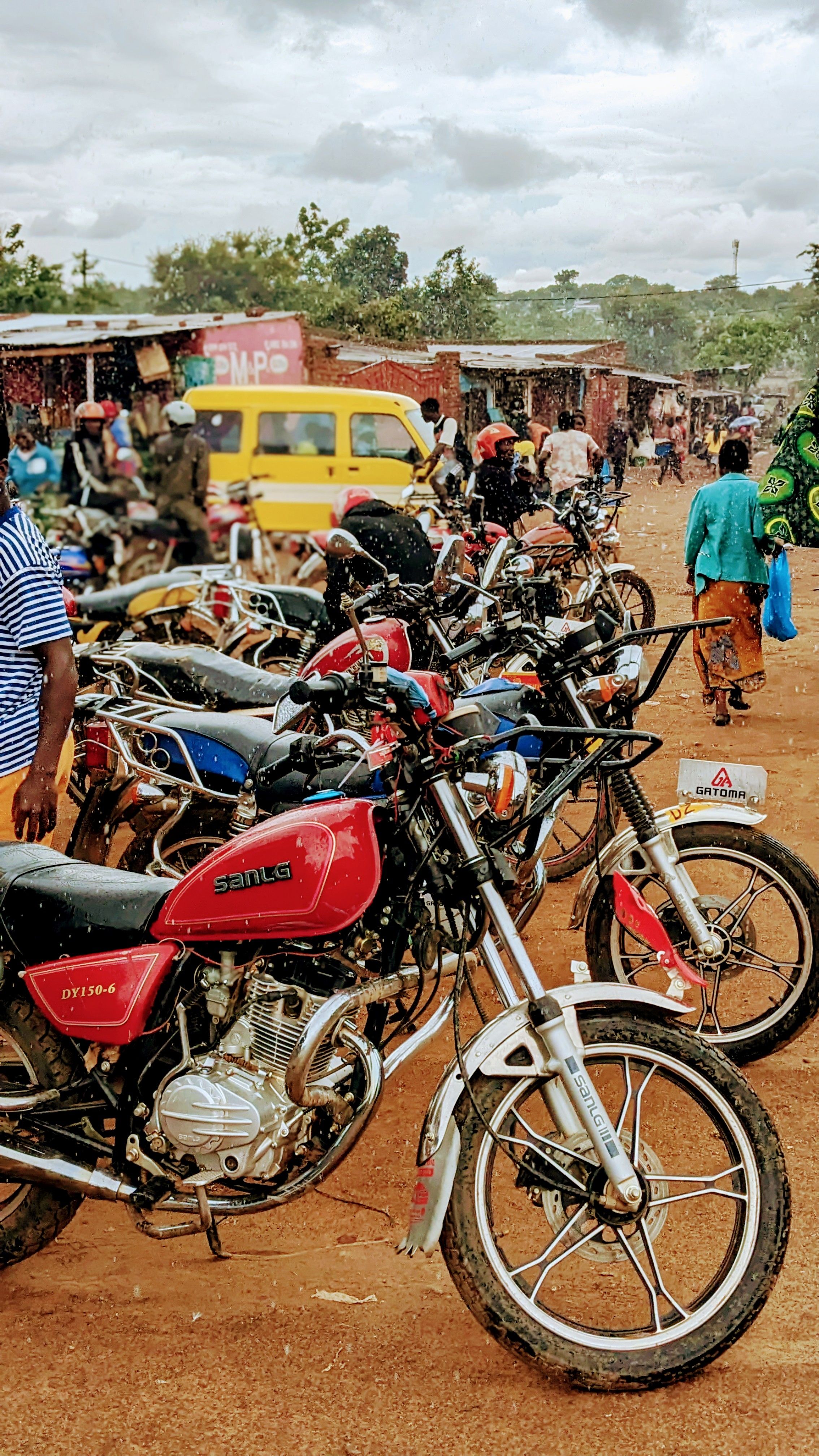 Vibrant Market Scene with Motorcycles and People · Free Stock Photo