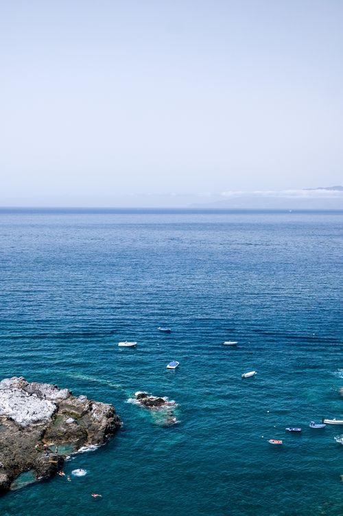 Free Aerial view of the Atlantic Ocean with boats near rocky shores in Canary Islands, Spain. Stock Photo