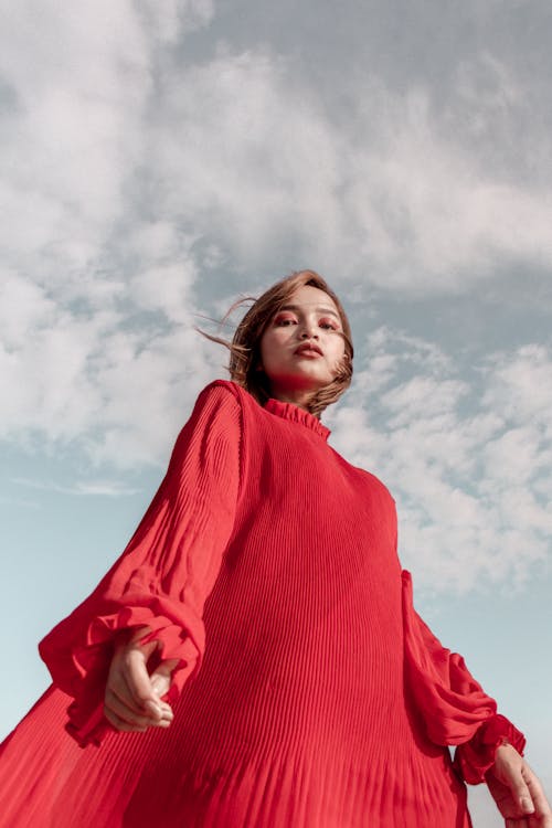 Low Angle Photo of Woman in Red Long-sleeved Dress