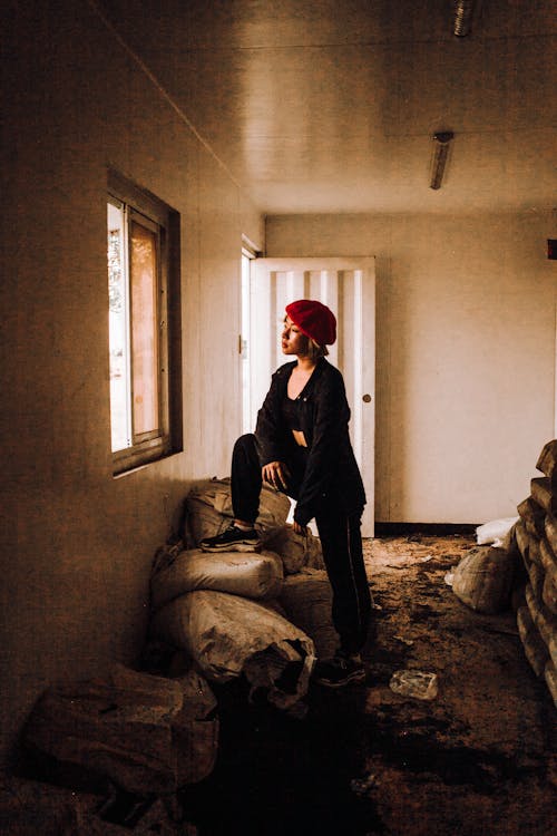 Woman Standing Beside Window