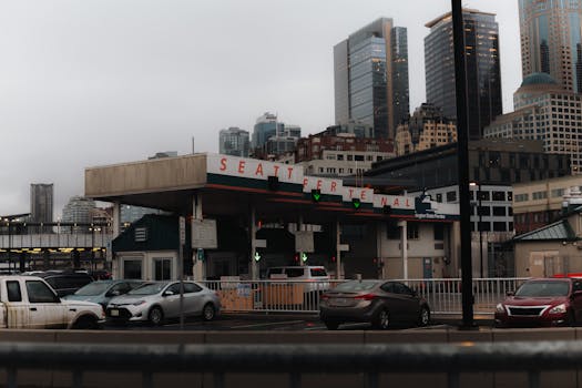 Seattle Ferry Terminal with city skyscrapers in background on an overcast day.