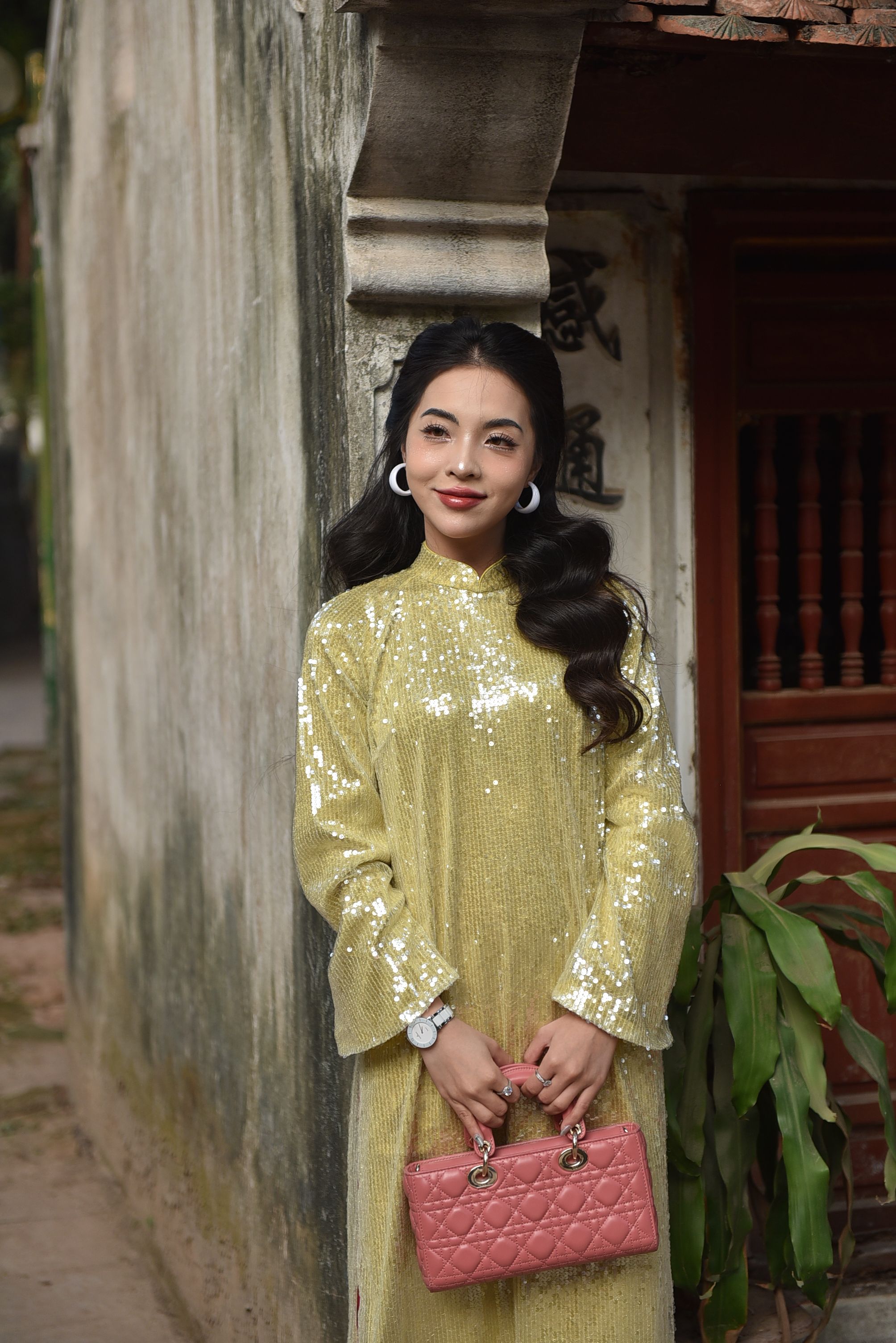 Elegant Woman in Gold Dress with Pink Purse  Free Stock Photo