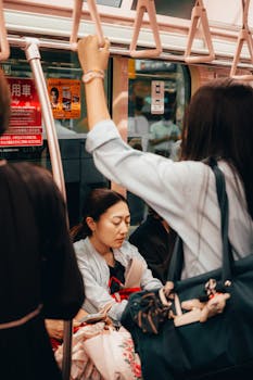 A candid view of commuters on a busy Tokyo train showcasing daily Japanese city life.