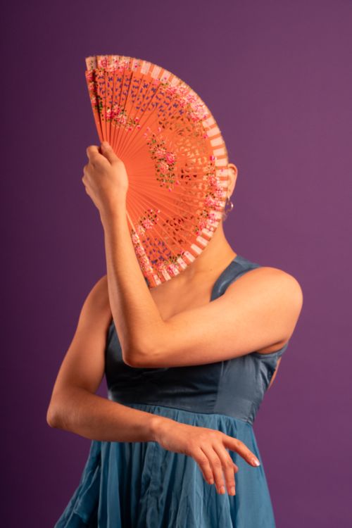 Free Model with fan obscuring face, highlighting Flamenco style in studio setting. Stock Photo