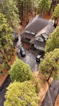 Aerial view of a secluded cabin in a forest, perfect for a serene getaway.
