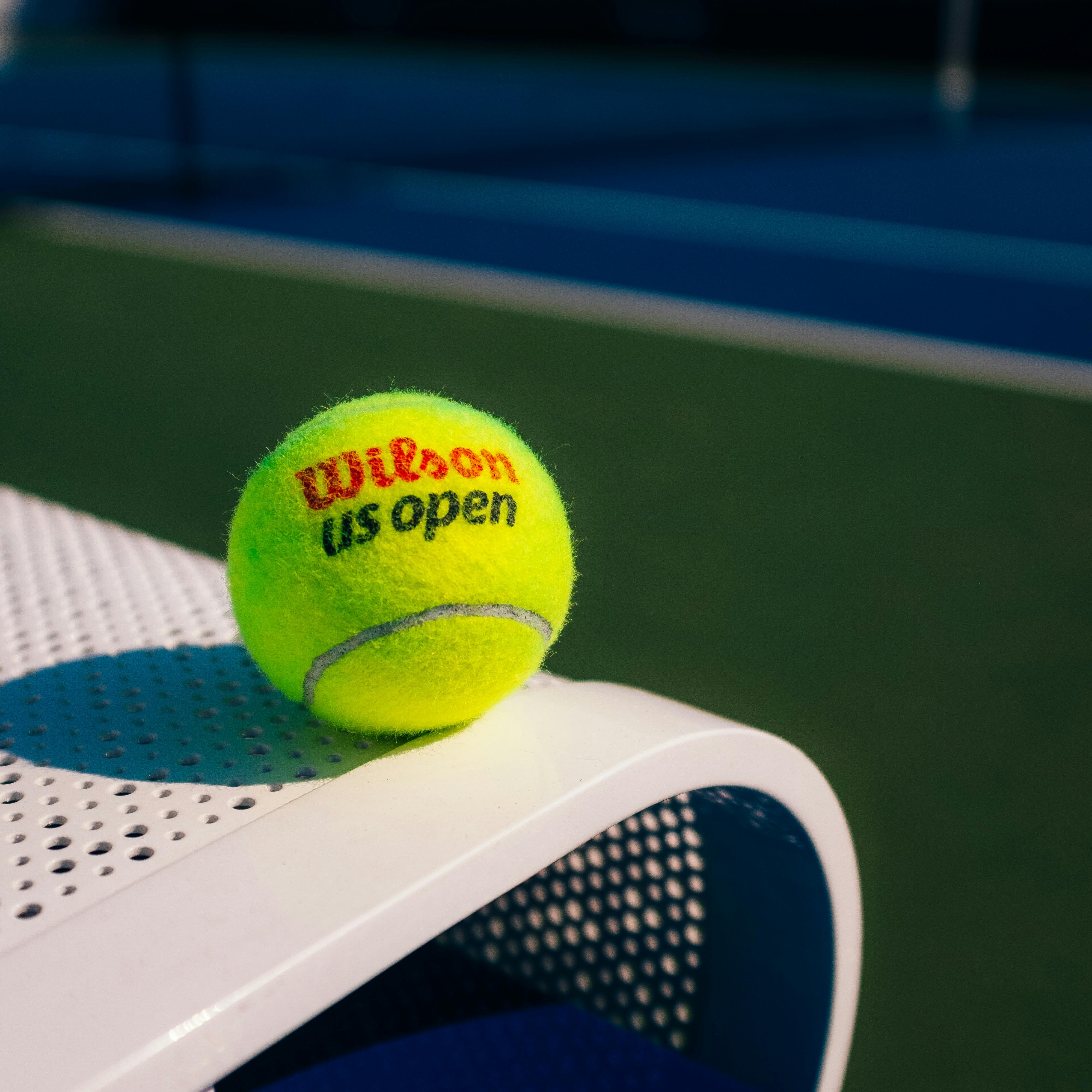 US Open tennis ball on court bench — free image from Pexels