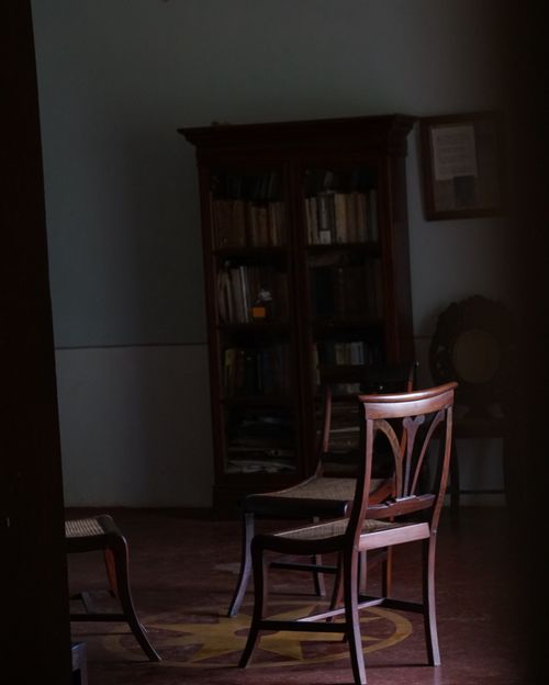 Free           chair lit in a dark room                      Stock Photo