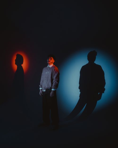 Free A creative portrait featuring a person with dynamic light and shadow effects creating a surreal ambiance. Stock Photo