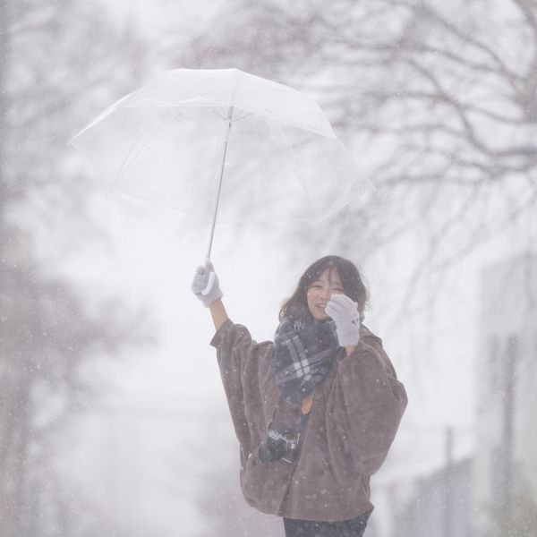 An open umbrella carried through falling snow — photo by travelers_tw on Pexels