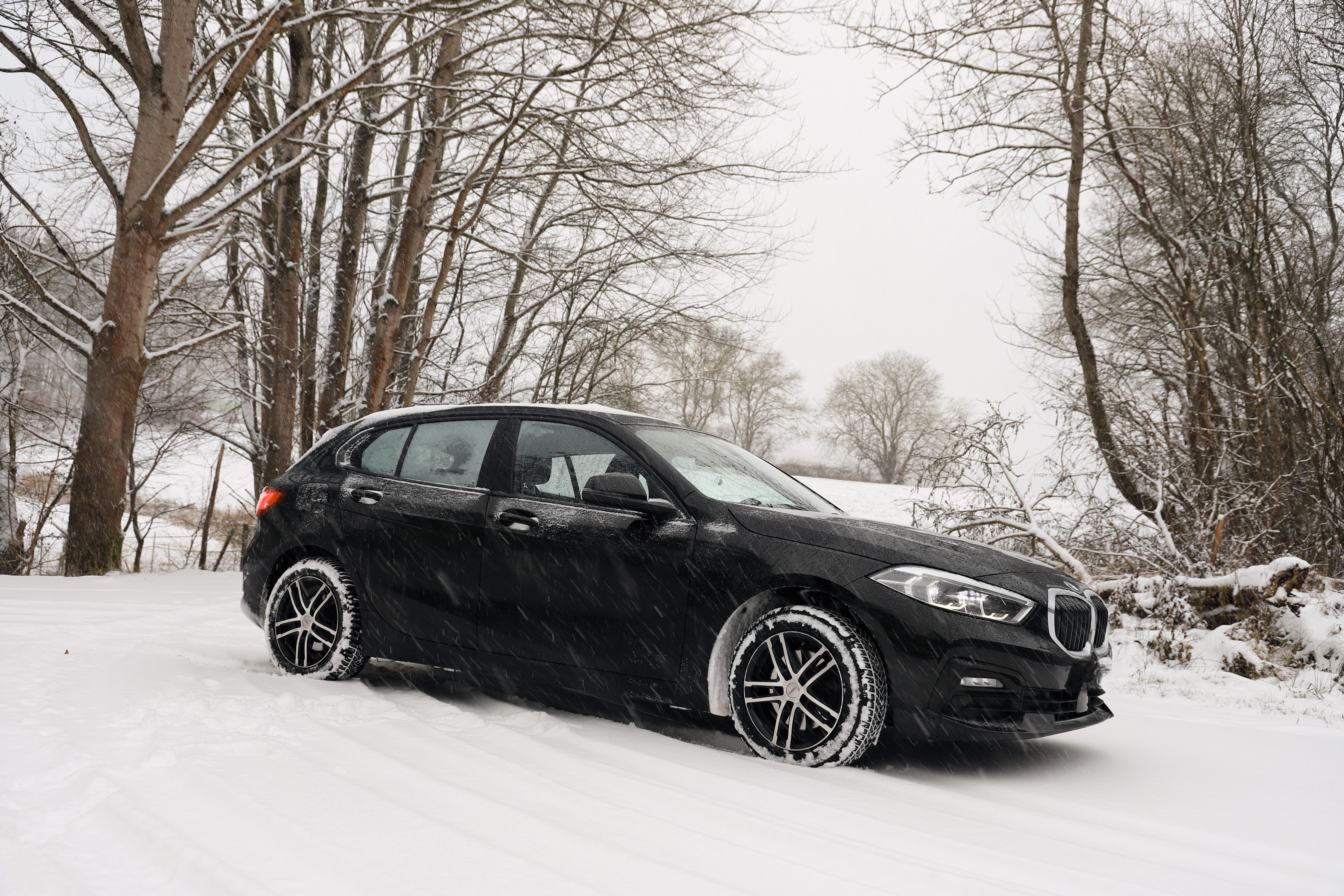 Car with winter tires on a snowy road in Latvia