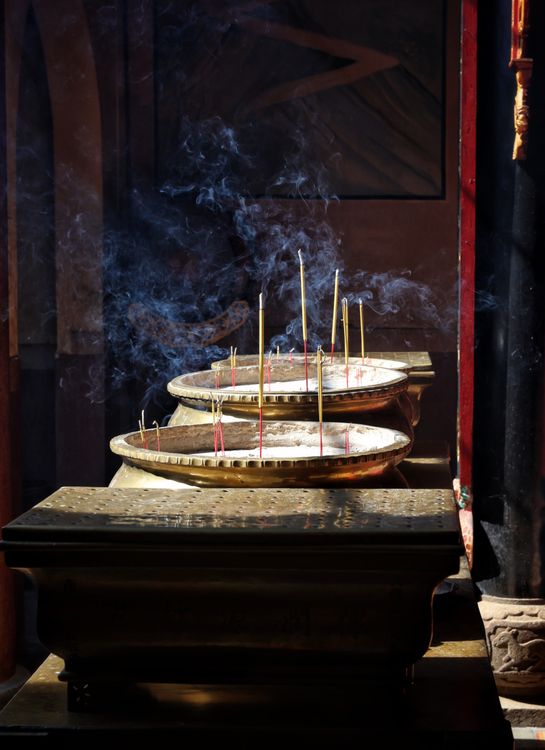 Traditional Incense Burning in Temple Setting · Free Stock Photo