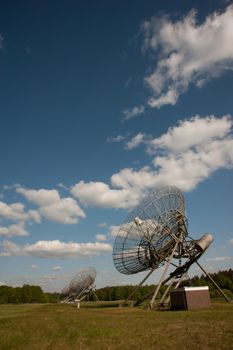 Radio telescopes in Dwingeloo, Drenthe, Netherlands against a clear blue sky.