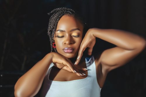 Free Elegant portrait of a woman with braided hair, expressing calmness and tranquility. Stock Photo