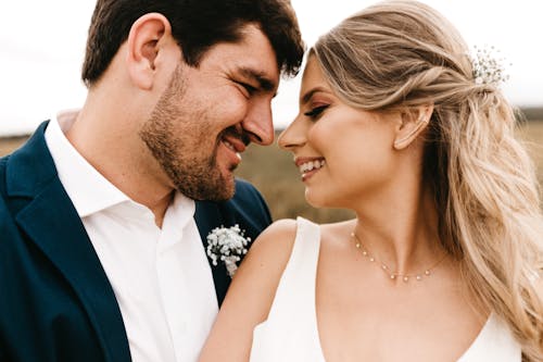 Free Man and Woman Facing Each Other While Smiling during Day Stock Photo