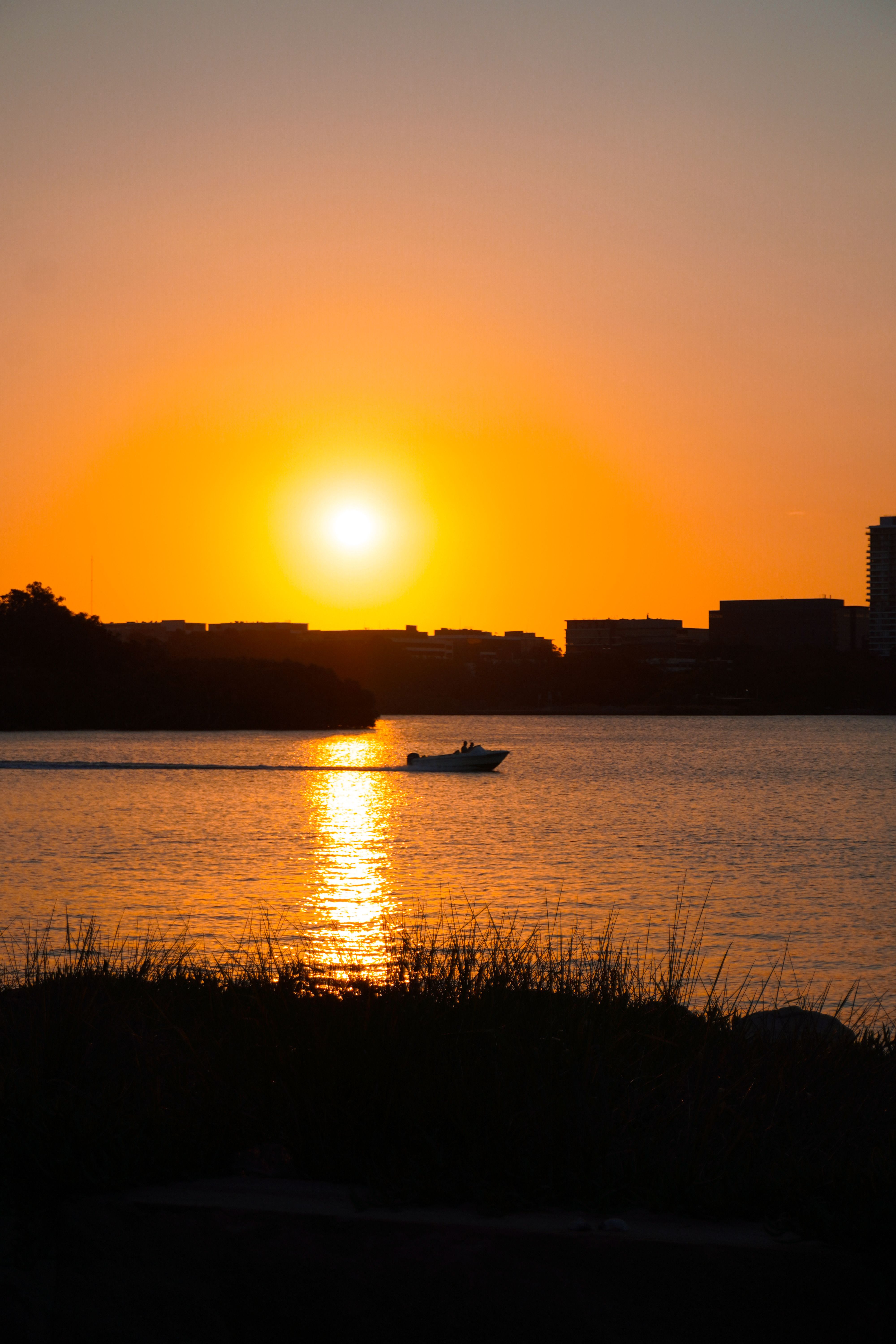 Boat Silhouetted Against a Vibrant Sunset · Free Stock Photo