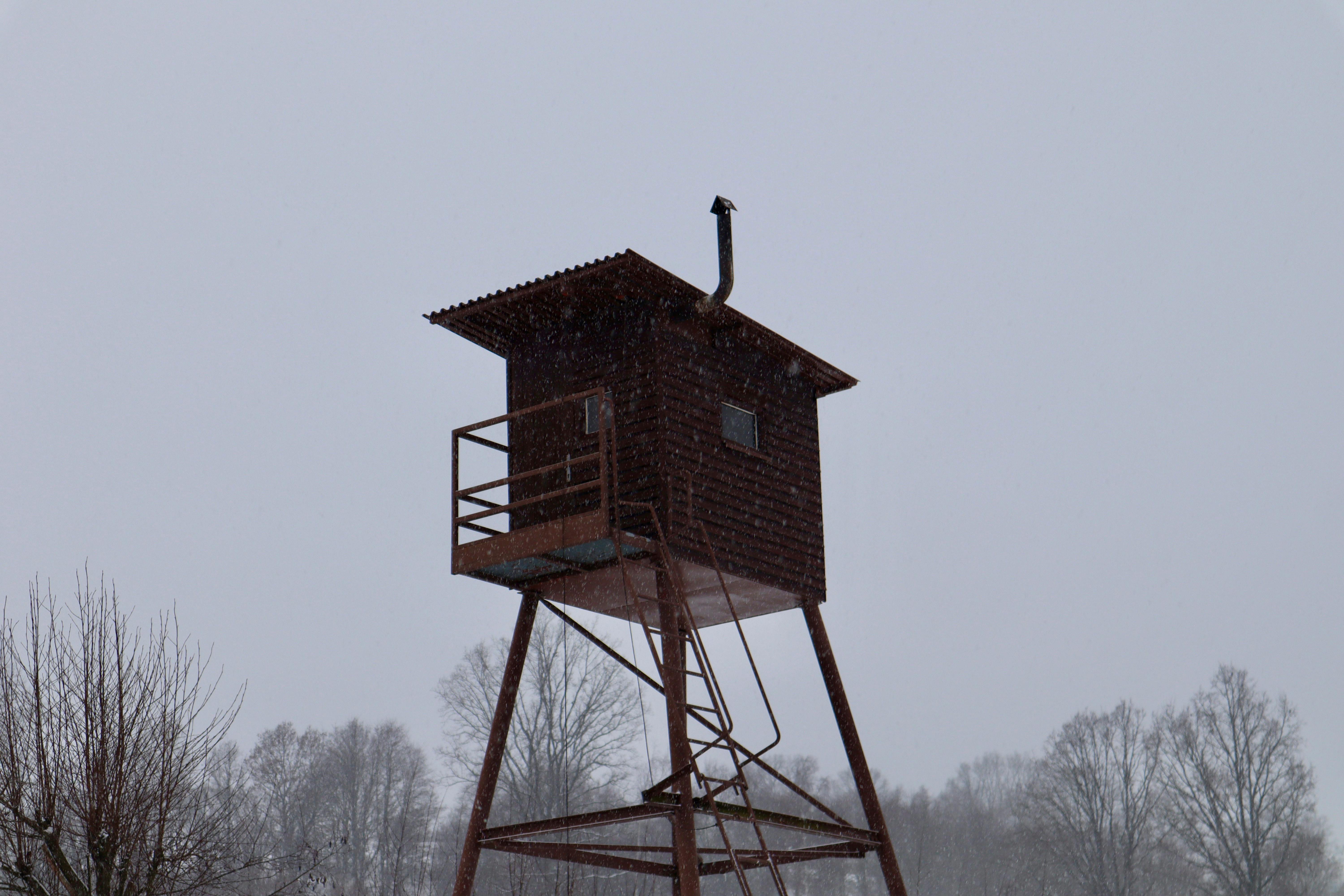 elevated wooden watchtower in snowy forest scene