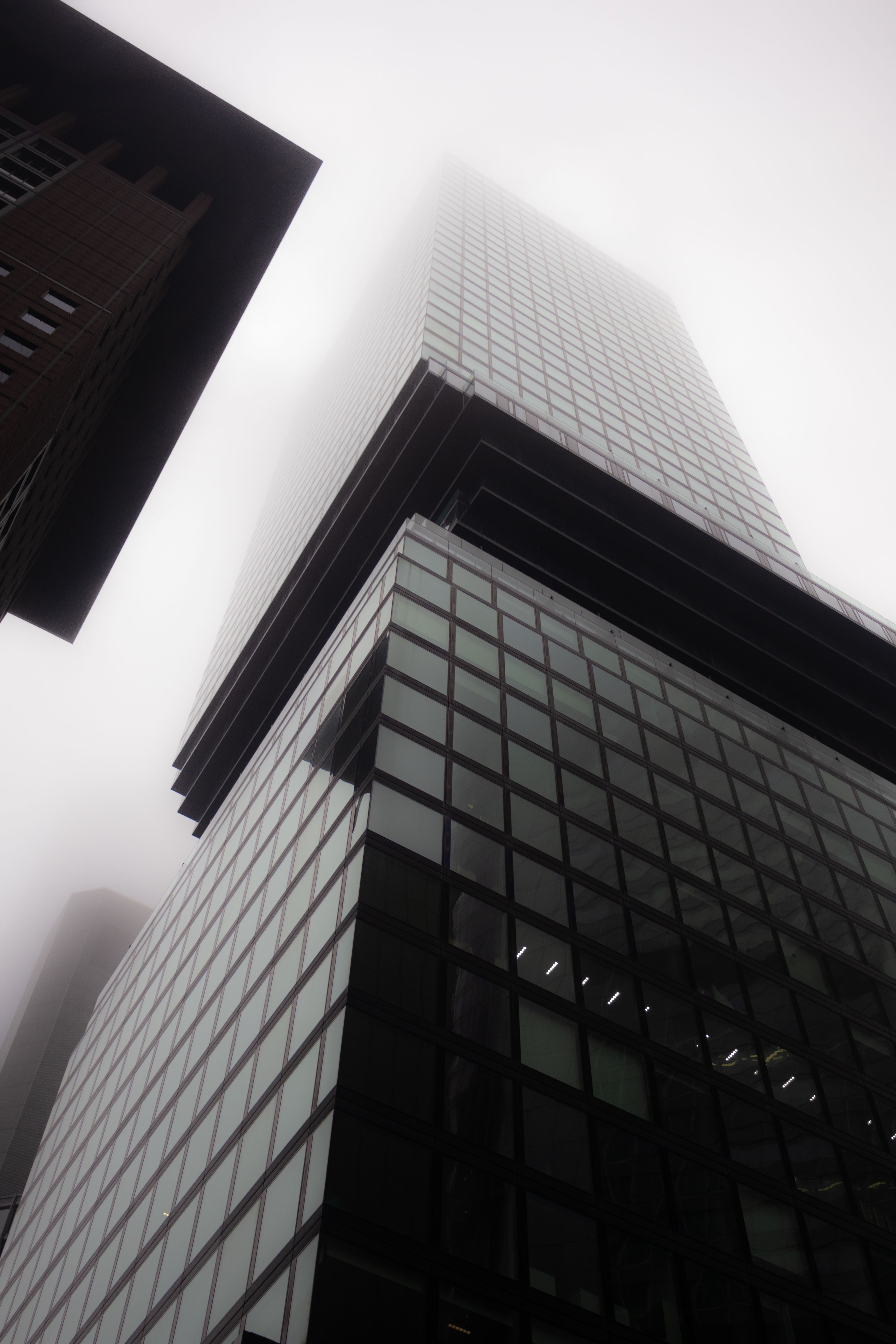 Foggy cityscape featuring a modern skyscraper in Frankfurt, Germany.