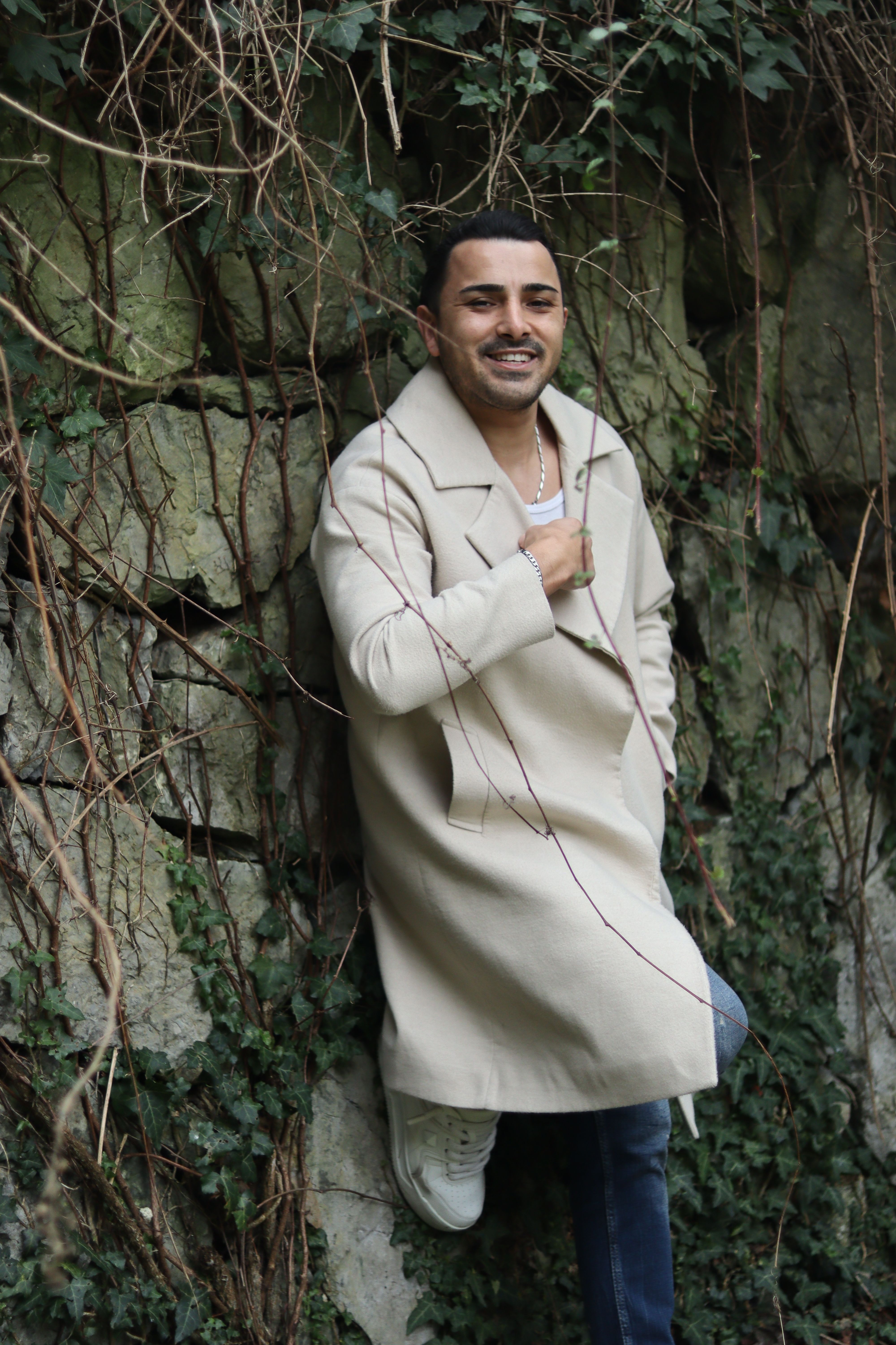 Stylish Man Posing Outdoors in Nature · Free Stock Photo
