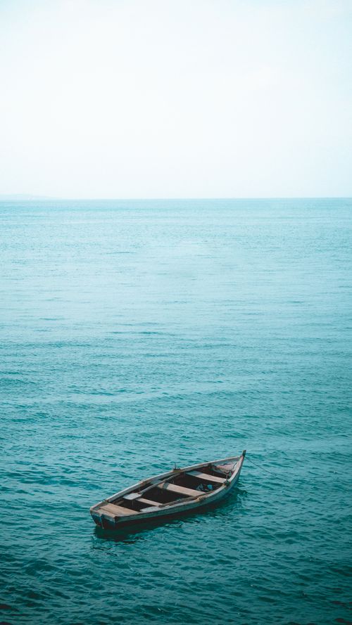Free Wooden boat gently floating on serene turquoise sea in Salvador, Brazil. Stock Photo