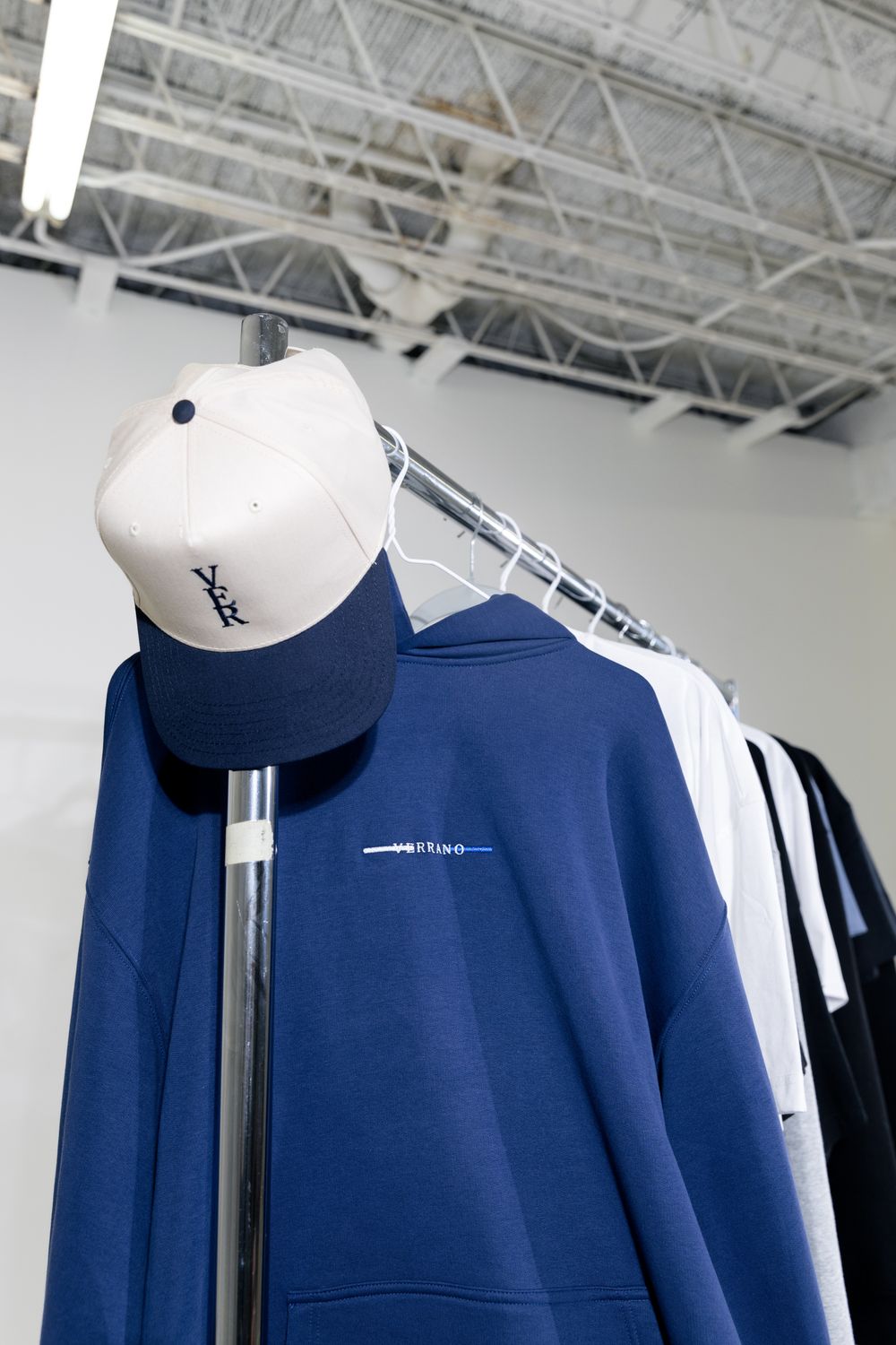 Casual Clothing Rack with Cap and Hoodie Display · Free Stock Photo